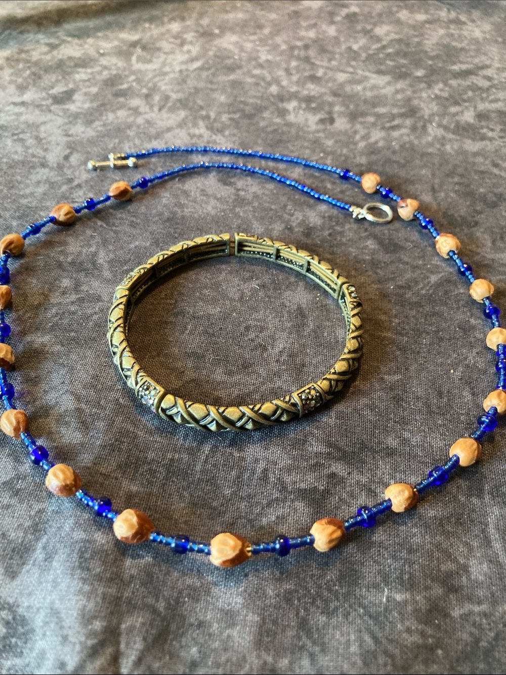 Blue Beaded Necklace with Carved Wooden Beads and Bronze Colored Stretch Bangle